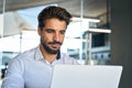 Busy young Latin business man looking at laptop using computer at work. Royalty Free Stock Photo