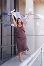 A busy young woman with papers in her hands, a happy business woman tosses the papers up Royalty Free Stock Photo