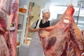 Butcher with animal carcass