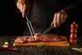Butcher or chef preparing raw fresh beef meat on cutting board before baking or barbecue. Recipe idea for a restaurant or hotel Royalty Free Stock Photo