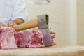 Butcher with a chisel handles raw pork Royalty Free Stock Photo