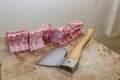 Butcher with a chisel handles raw pork Royalty Free Stock Photo
