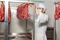 Butcher controls sausage Royalty Free Stock Photo