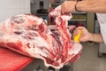 Butcher cutting meat in the butchery. Close up Royalty Free Stock Photo