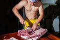 Butcher cutting pork meat on kitchen, chef cutting fresh raw meat on table