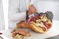 Butcher deboning an Italian prosciutto ham Royalty Free Stock Photo