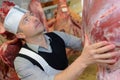 Butcher holding side beef