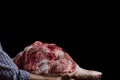 Butcher with meat. Pork thigh in hand Royalty Free Stock Photo