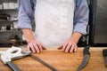 A butcher poses behind his tools and block Royalty Free Stock Photo