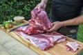 Butcher prepares meat for rolled roast pork