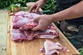 Butcher prepares meat for rolled roast pork