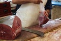 Butcher prepares a tuna stack n Funchal fish market