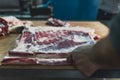 butcher preparing meat in a butcher shop, pig meat concept Royalty Free Stock Photo