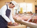 Butcher Preparing Meat In Shop Royalty Free Stock Photo