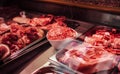 Butcher shop counter filled with varoius raw cool meat