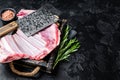 Butcher table with Rack of lamb, raw mutton ribs with meat cleaver. Black background. Top view. Copy space Royalty Free Stock Photo