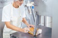 Butcher woman using saw to cut meat in her butchery