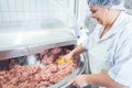 Butcher woman working on meat in butchery