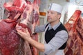 butcher works with carcasses