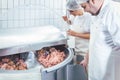 Butchers in butchery processing meat