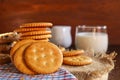 butter biscuits cracker and milk set up on napkin and wooden background Royalty Free Stock Photo