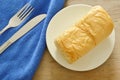 Butter bread loaf on white dish with table knife and fork Royalty Free Stock Photo