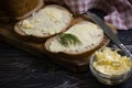 Butter, bread, parsley on a wooden background sliced Royalty Free Stock Photo
