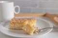 Butter cake with almond, sugar topping. Traditional german yeast cake served on a plate