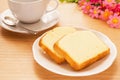 Butter cake sliced on plate and coffee cup, filtered image Royalty Free Stock Photo