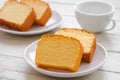 Butter cake sliced on white plate and coffee cup Royalty Free Stock Photo