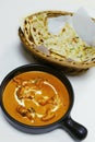 butter chicken curry or masala with garlic naan, indian food delicacy, chicken cooked in rich tomato cashewnut gravy Royalty Free Stock Photo