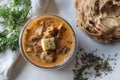 Butter chicken made of grilled chicken chunks cooked in buttery creamy tomato gravy served with kerala parotta