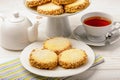 Butter cookies (alfajores) with caramel and peanut and cup of tea on wooden background. Royalty Free Stock Photo