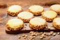 Butter cookies (alfajores) with caramel and peanut on wooden background. Royalty Free Stock Photo