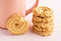 Butter cookies and coffee cup on pink background Royalty Free Stock Photo