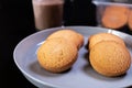 butter cookies on a white plate with a cup of coffee on a black background Royalty Free Stock Photo