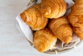 Butter croissants in small wicker basket. Aerial top view on c Royalty Free Stock Photo