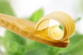 Butter curl on a wooden spoon Royalty Free Stock Photo