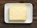 Butter dish on wooden table, from above Royalty Free Stock Photo