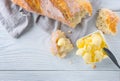 Butter and fresh crunchy homemade bread. Healthy organic breakfast on rustic white wooden table Royalty Free Stock Photo