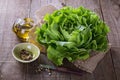 Butter lettuce and oil over rustic background