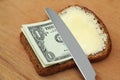 Butter and money on bread Royalty Free Stock Photo