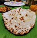 Butter naan (a type of Indian flat bread) served with chicken curry and kababs