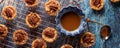 Butter Pecan tartlets on a copper wire cooling rack ready for eating.