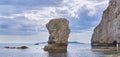 Butter Rock and Bat\'s Head under blue sky and white clouds