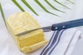 Butter. Slice of butter. Fresh sliced butter on dish on white and green background Royalty Free Stock Photo