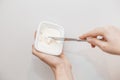 Butter on a slice of knife. Steel knife over a briquette piece of a butter. isolated over the white background. A tub of Royalty Free Stock Photo