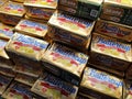 Butter in square packaging is on display on chiller shelves inside the supermarket.