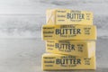 Butter sticks close-up. Wrapped organic unsalted butter sticks on a light grey background Royalty Free Stock Photo