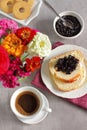 Butter vanilla brioche with cheery jam and coffee for breakfast